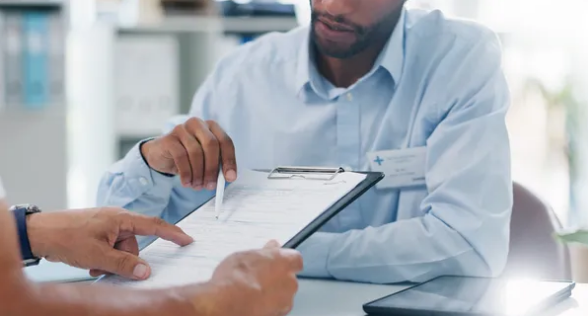 Insurance consultant reviewing documents with client